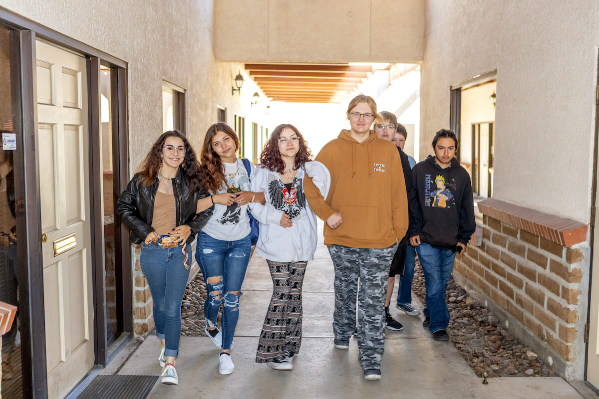 Edge alternative charter high school students walking down a hallway arm in arm