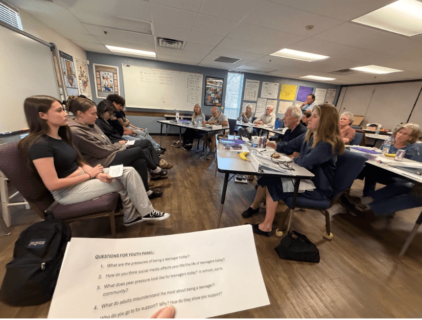 Edge High School students collaborate with success coaches in a classroom. What Coaches Witnessed 